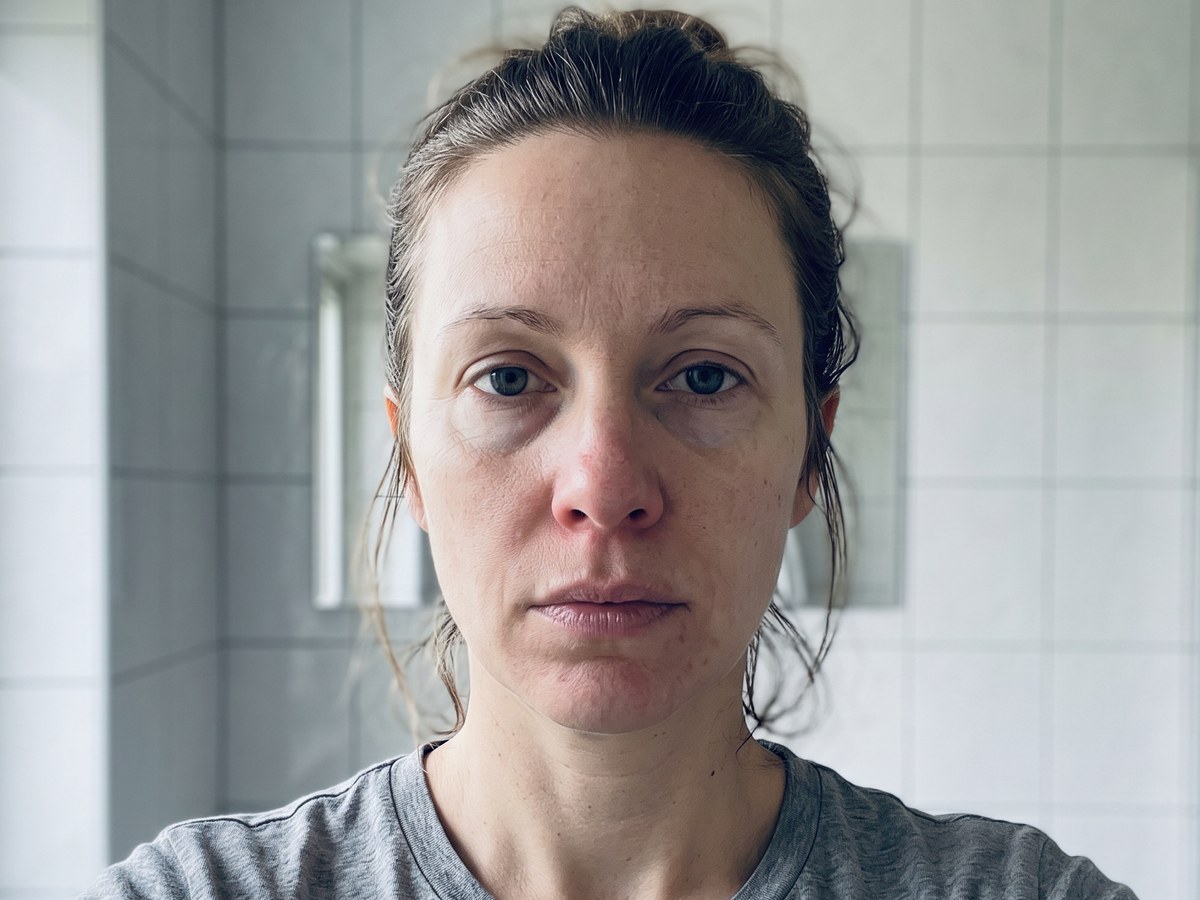 The same woman before starting, photographed without makeup in morning window light